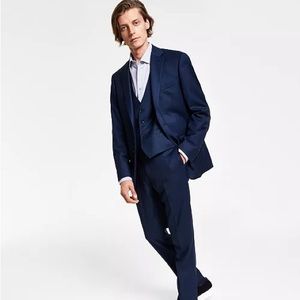 Slim fit and sleek sharkskin fabric of this Blue Birdseye suit from CK,100% Wool